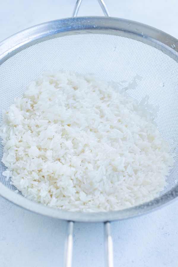 Rice is rinsed in the sink before cooking.