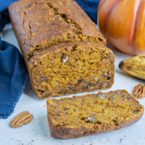 A loaf of pumpkin banana bread is sliced and served for a healthy treat.