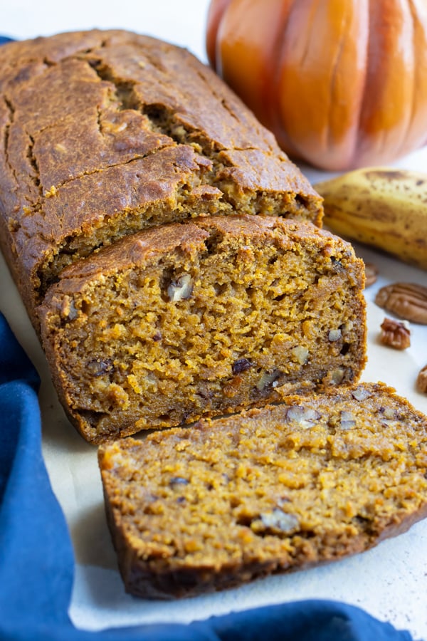 Nuts are shown inside the pumpkin banana bread.