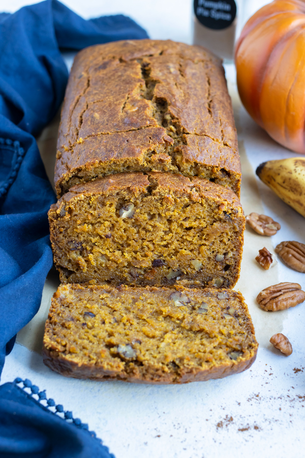 Pumpkin banana bread is shown on the counter in slices.