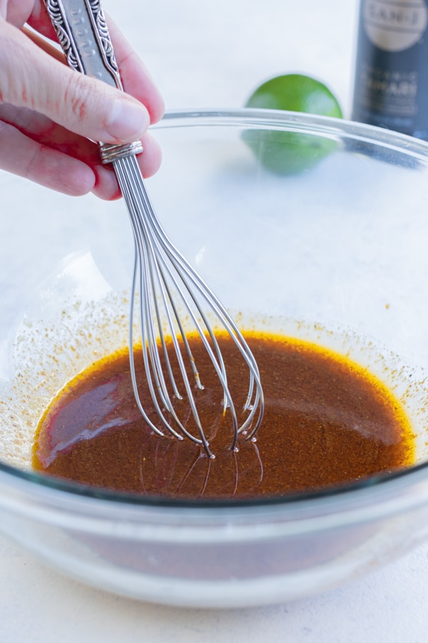 The marinade is made by mixing the liquid ingredients and taco seasoning in a bowl.