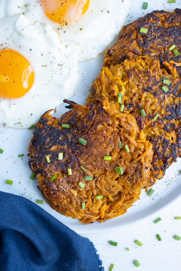 Fried eggs and hash browns are served for breakfast