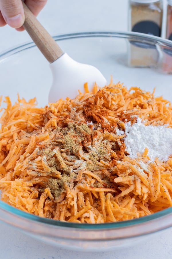 Seasonings and flour are mixed into the sweet potatoes.