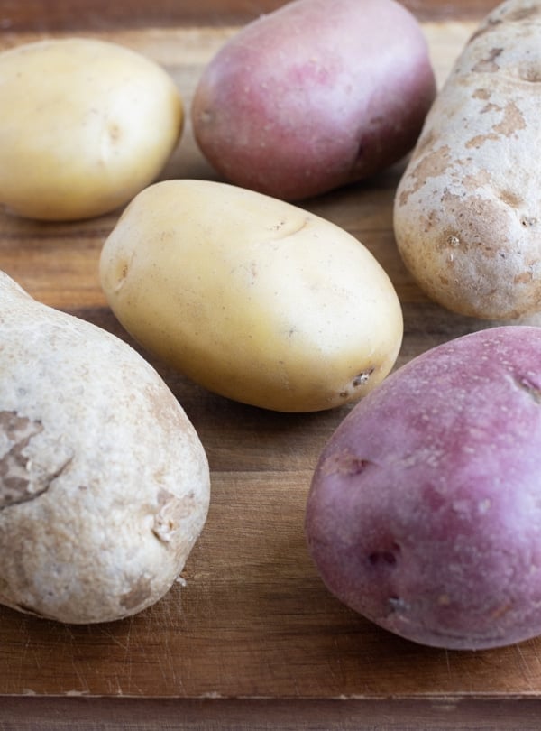 Raw potatoes are shown on the counter.