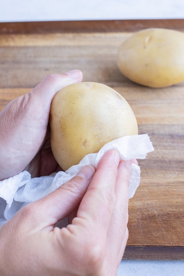 Potatoes are wiped clean on the outside with a paper towel.