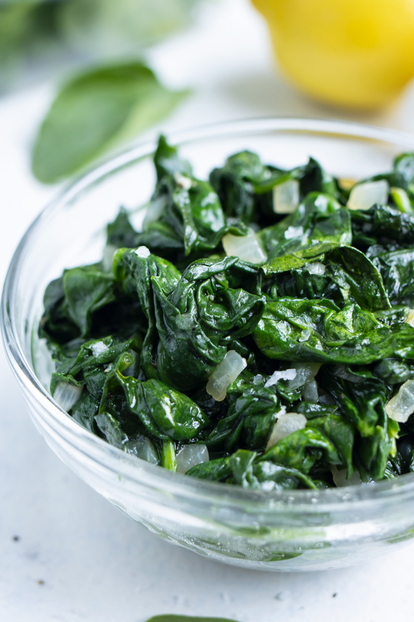 Spinach is served in a bowl for a side dish.