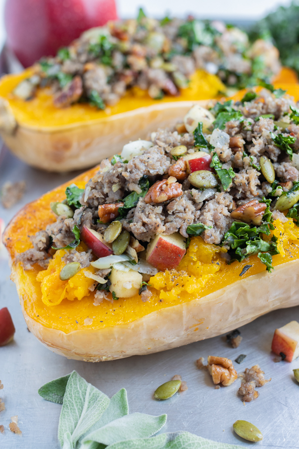 Sausage, apple, and kale are stuffed in a roasted butternut squash.