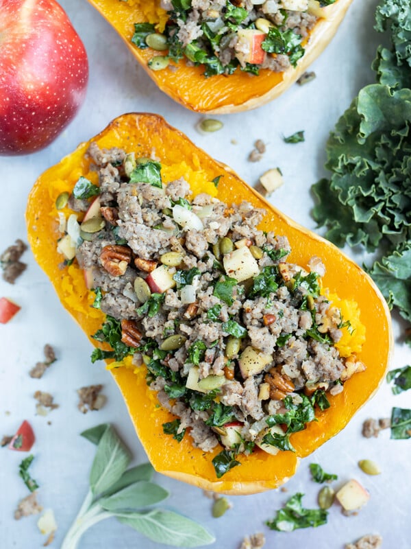 An overhead shot shows a butternut squash stuffed with a sausage mixture.