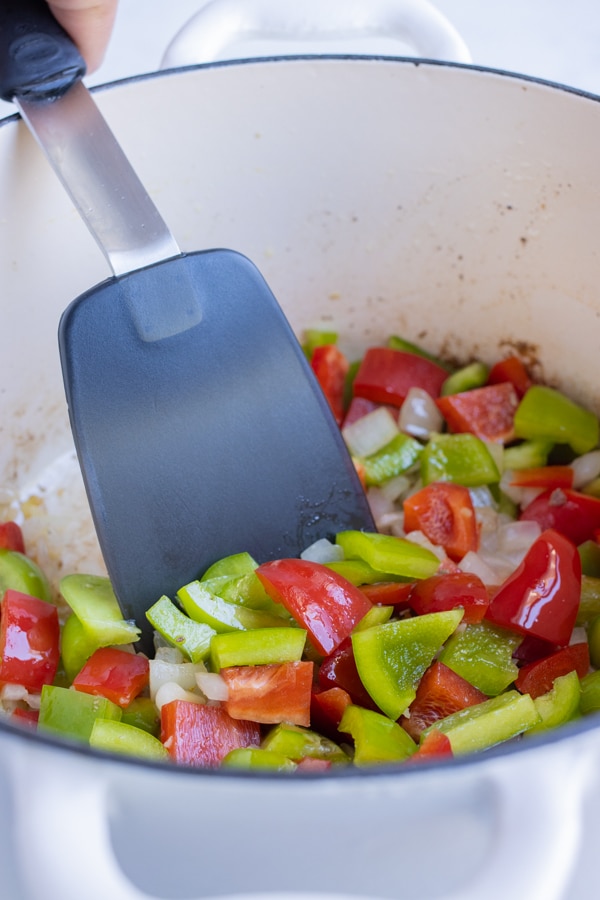 Bell peppers are added to the pot and cooked.
