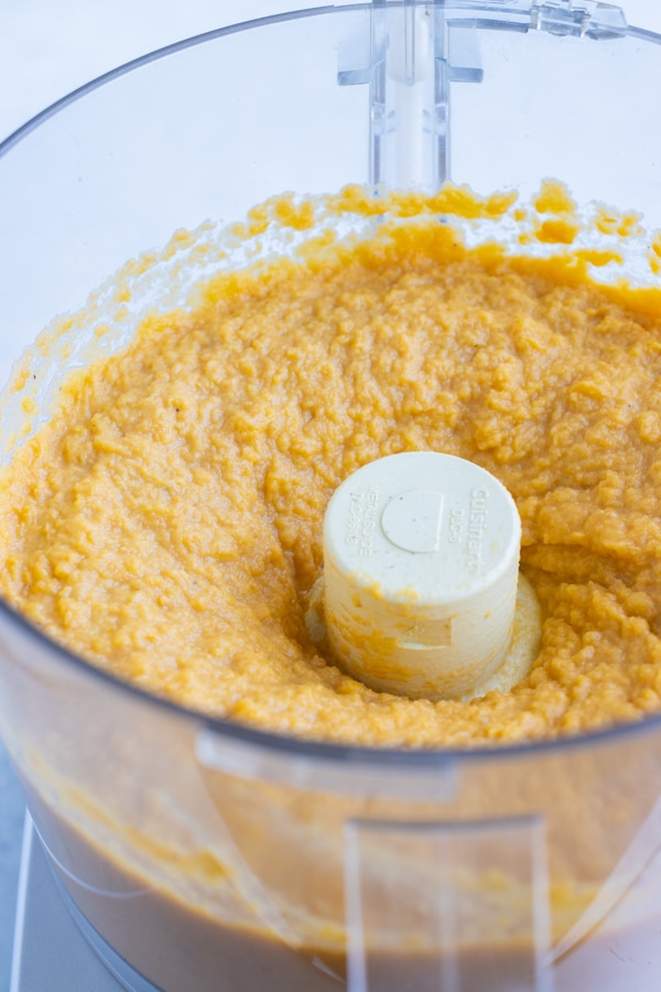 Sweet potatoes are puréed in a food processor.