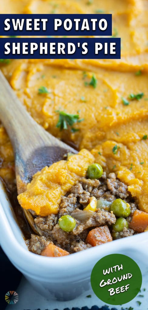 A serving of healthy sweet potato shepherd's pie is dished with a wooden spoon.
