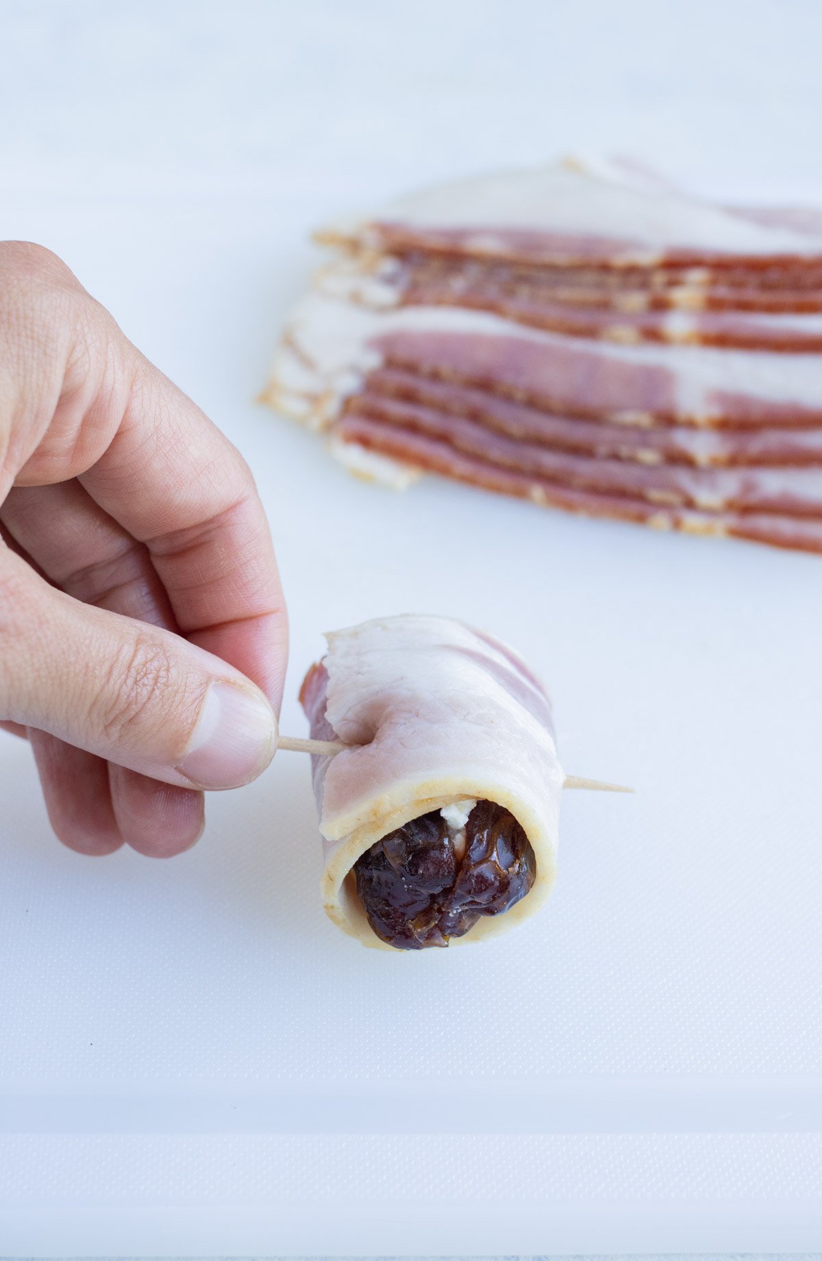 Tooth pick is placed in the bacon to hold all the ingredients together.