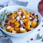 Butternut squash, goat cheese, and pomegranate are served for a holiday recipe.