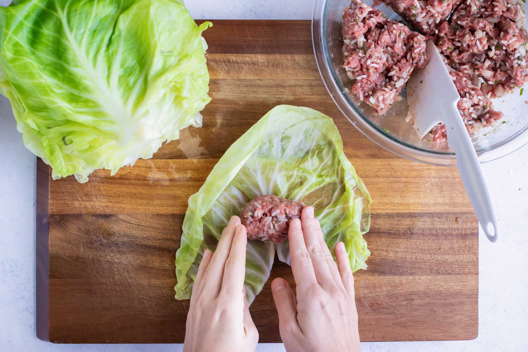 Beef mixture is placed in the cabbage leaf before rolling.