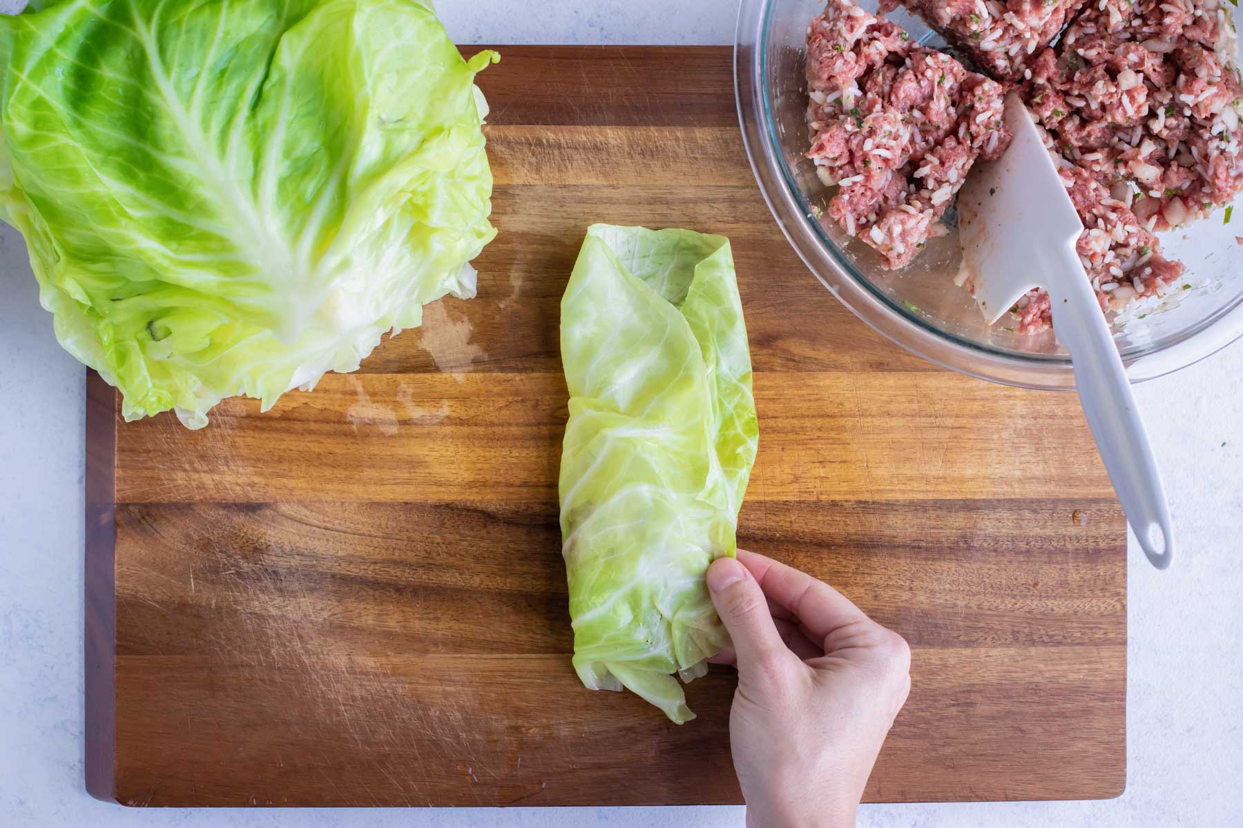 Cabbage leaf is folded into a roll.