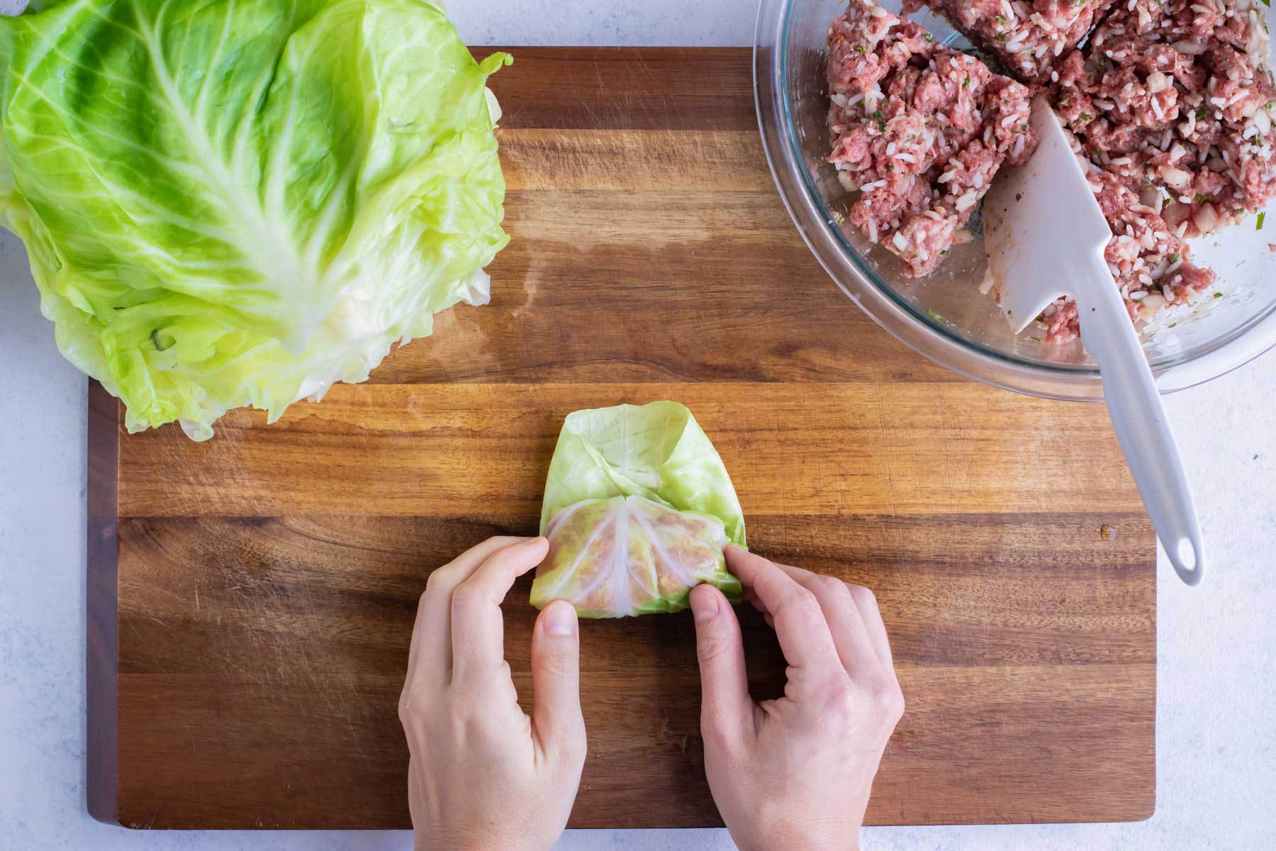 Cabbage leaf with filling is rolled in
