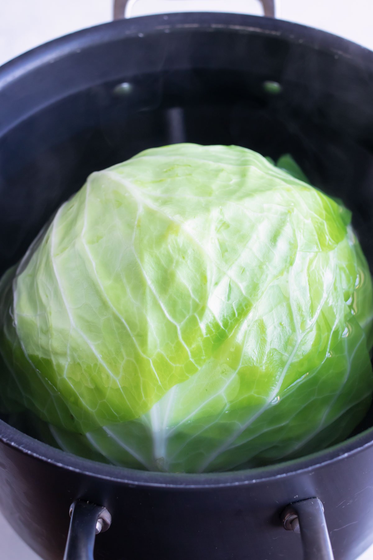 Cabbage head is par-boiled before separating leaves.