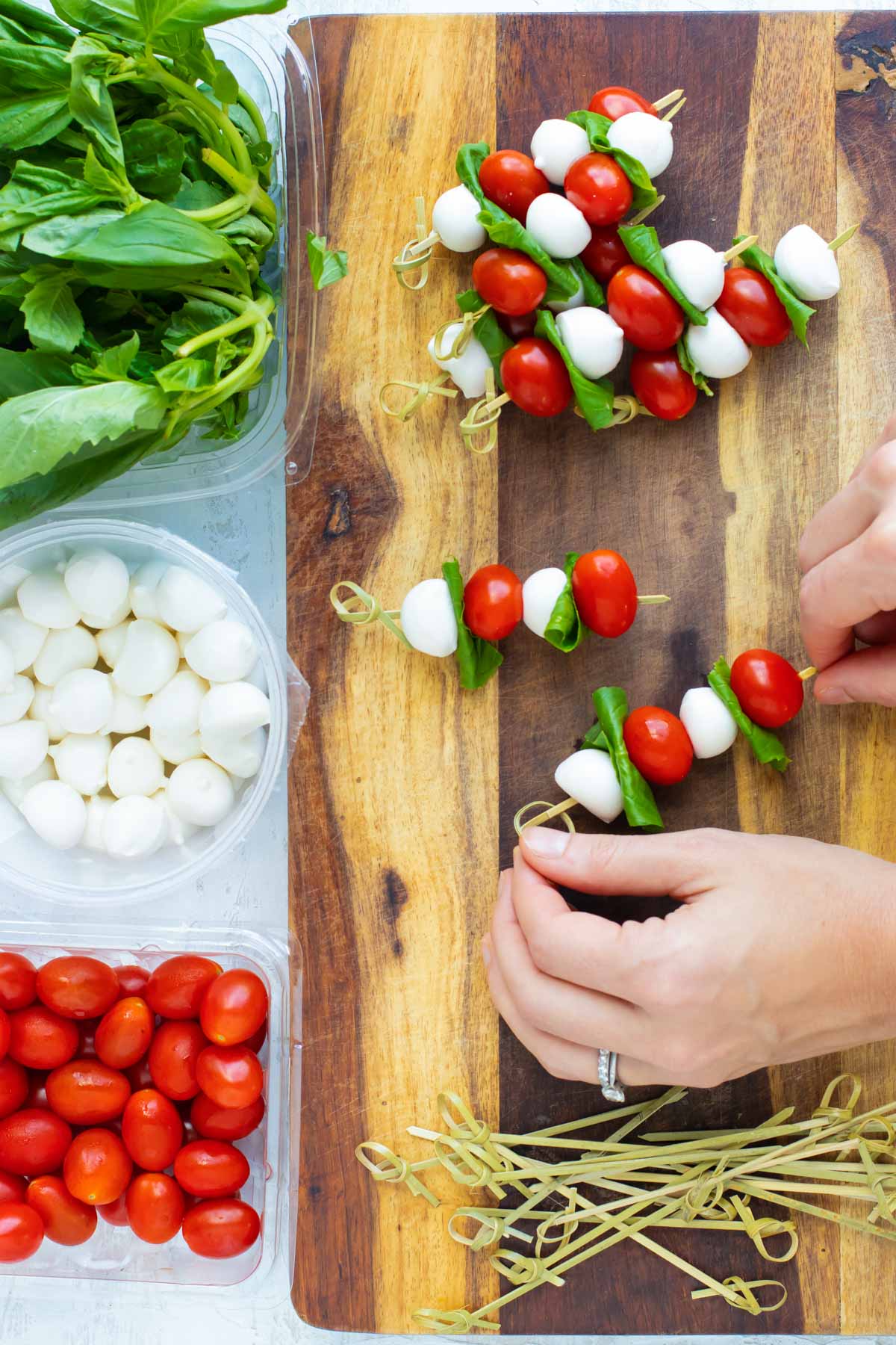 How to assemble caprese salad onto wooden skewers.