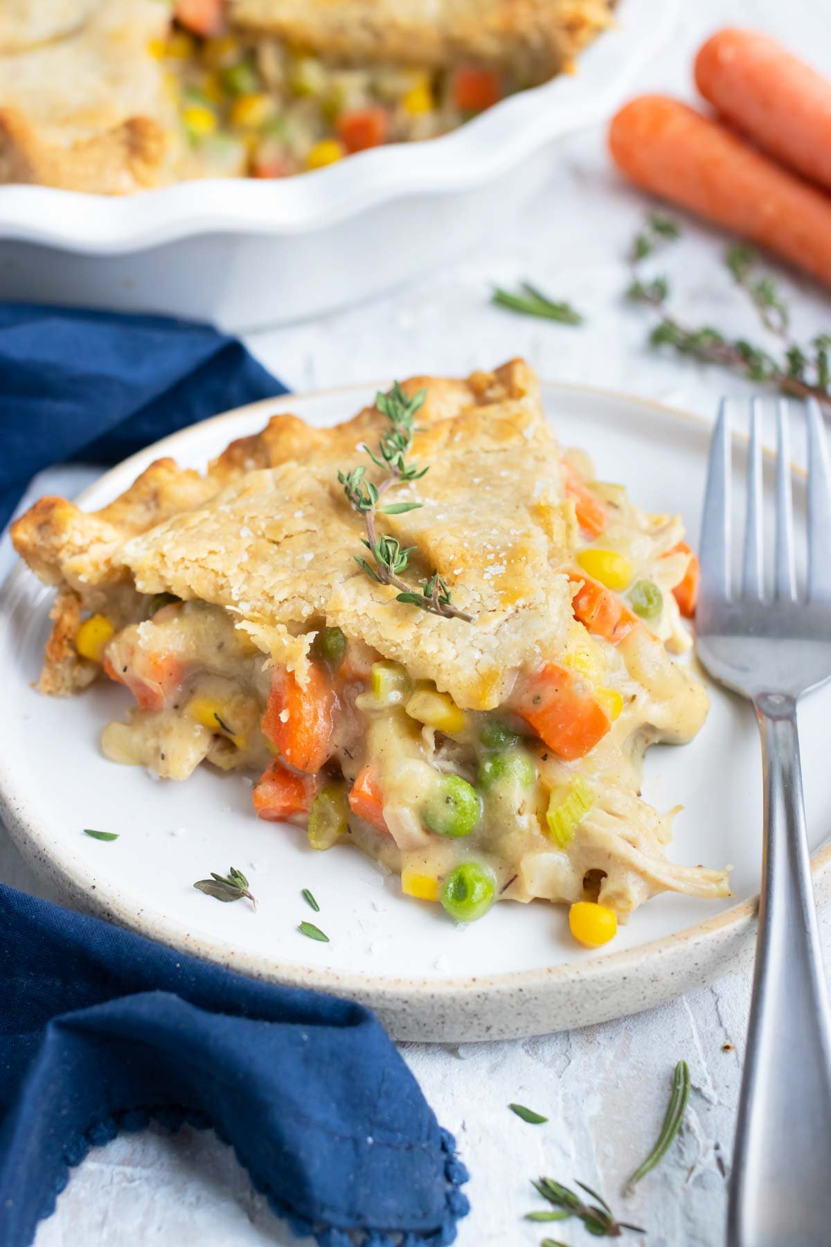 A slice of a gluten-free and dairy-free chicken pot pie recipe on a white plate with a fork.