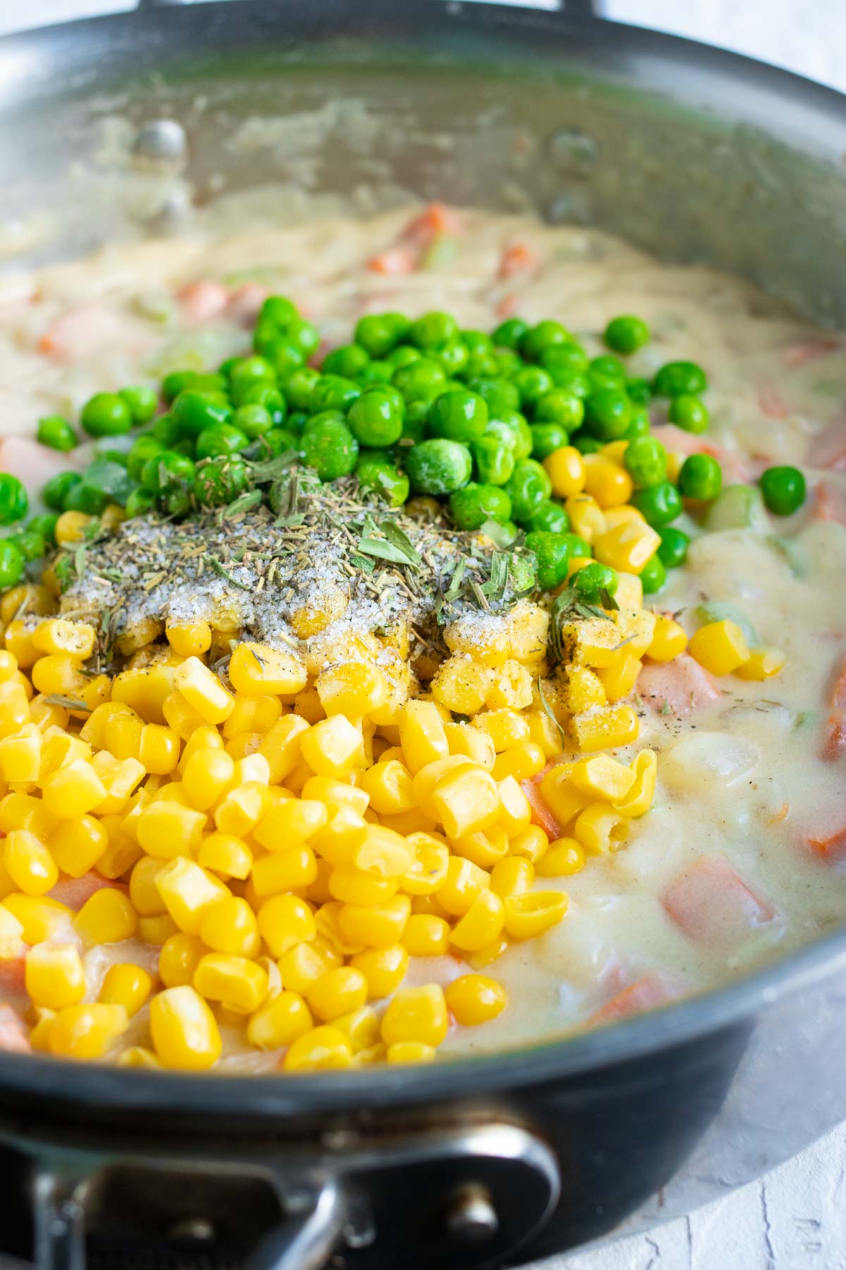 Corn, peas, and herbs are added to the filling.
