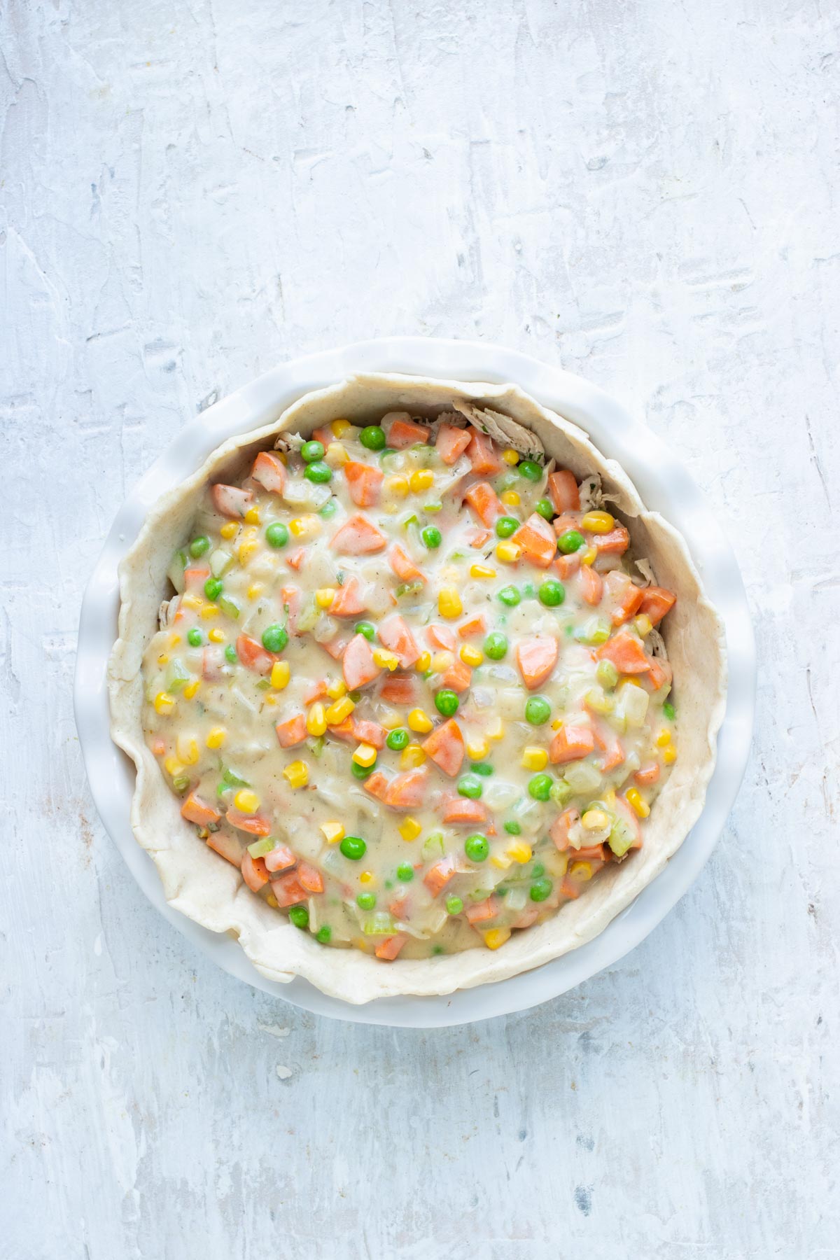 Pot pie filling is added to the pie crust.