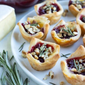 A plate of cranberry brie bites are served for a Thanksgiving appetizer.