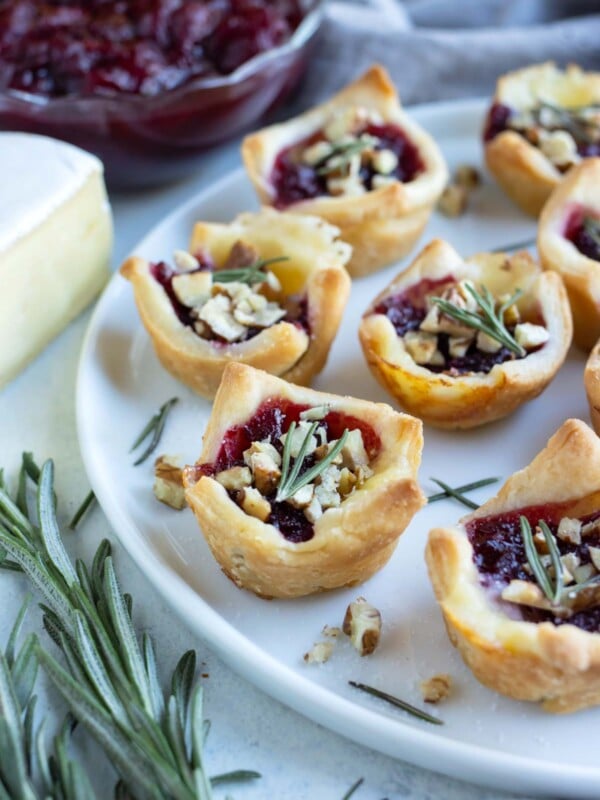 A plate of cranberry brie bites are served for a Thanksgiving appetizer.