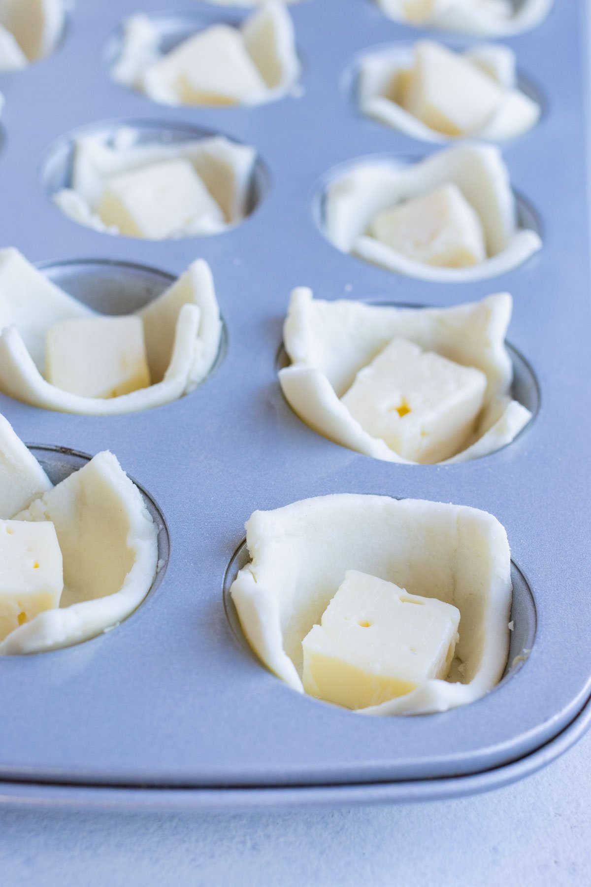 A square of brie is put inside the puff pastry.