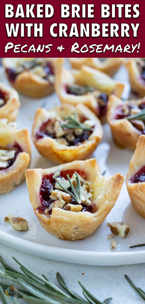A plate of brie and cranberry filled puff pastry bites are shown on the counter.