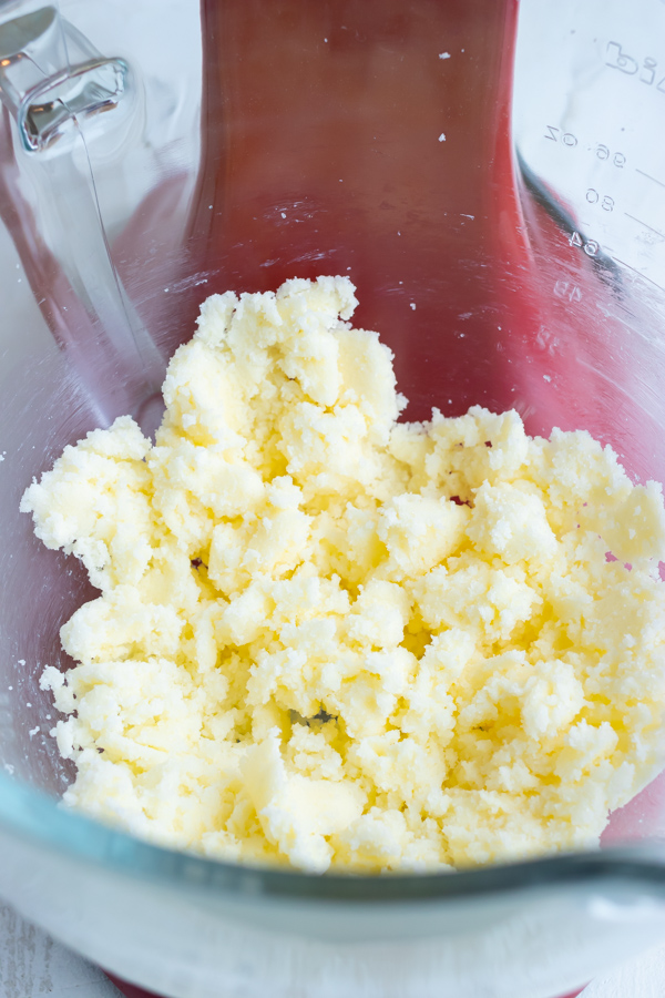 Butter and sugar mixed together in the bowl of a stand mixer.