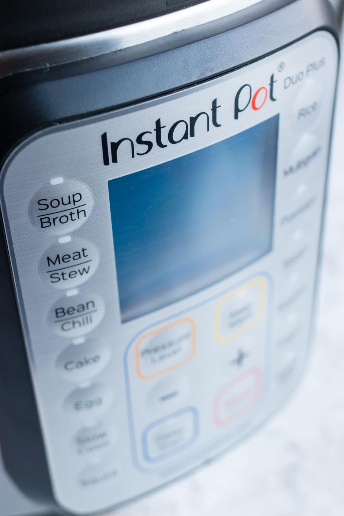 A close-up image of the Instant Pot Duo plus control panel and LCD display.