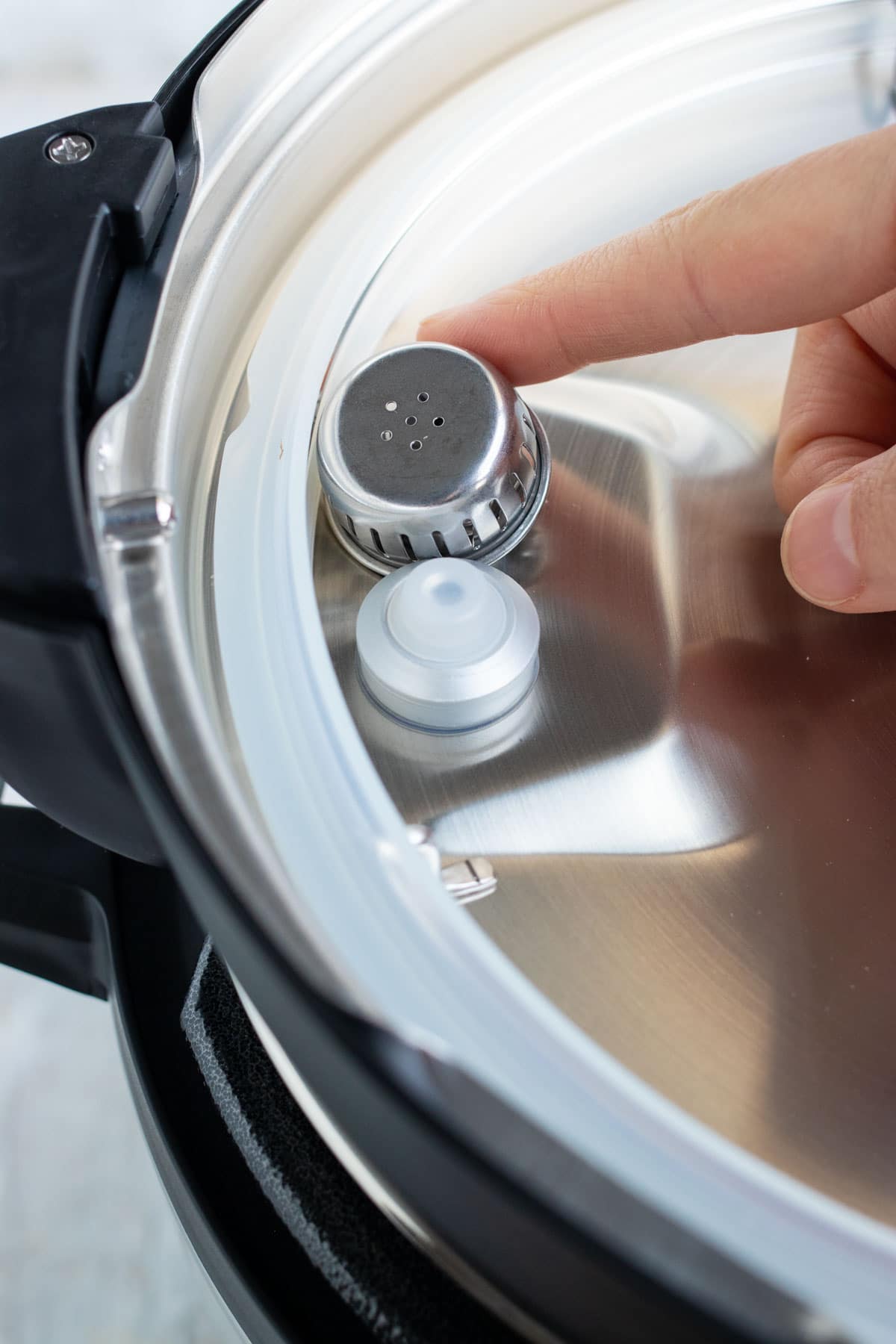 An image showing the anti-block shield of a pressure cooker.