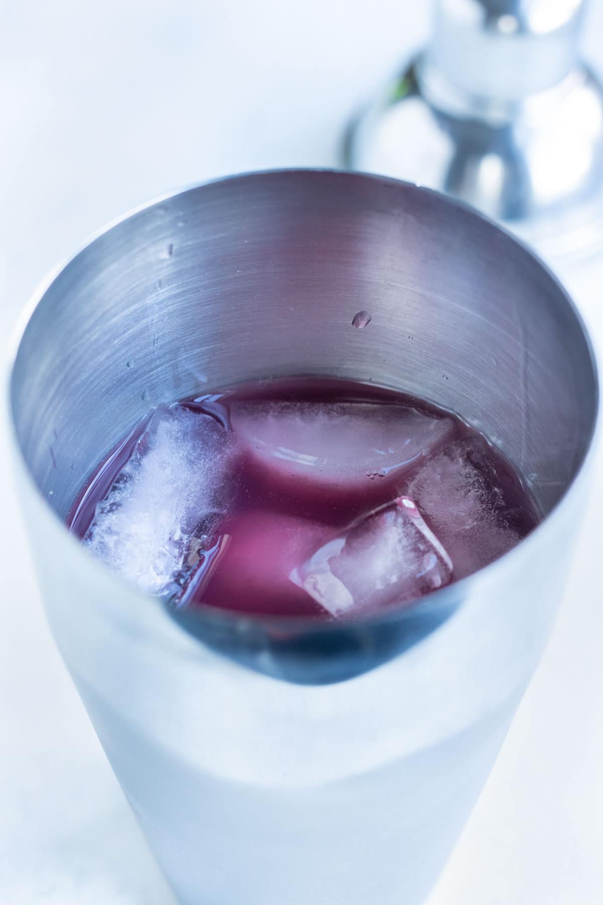 Ingredients and ice are added to the shaker while making this drink.