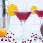 Pomegranate Martinis are shown on the counter next to the shaker.