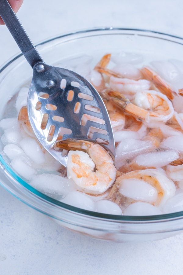 Shrimp is transferred into an ice bath.