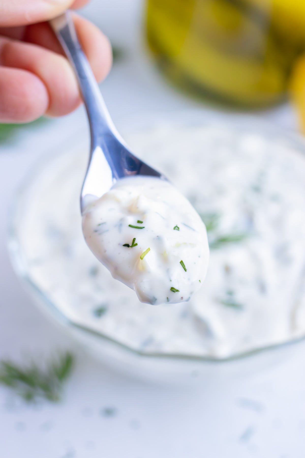 A spoonful of from-scratch tartar sauce lifted out of the bowl.