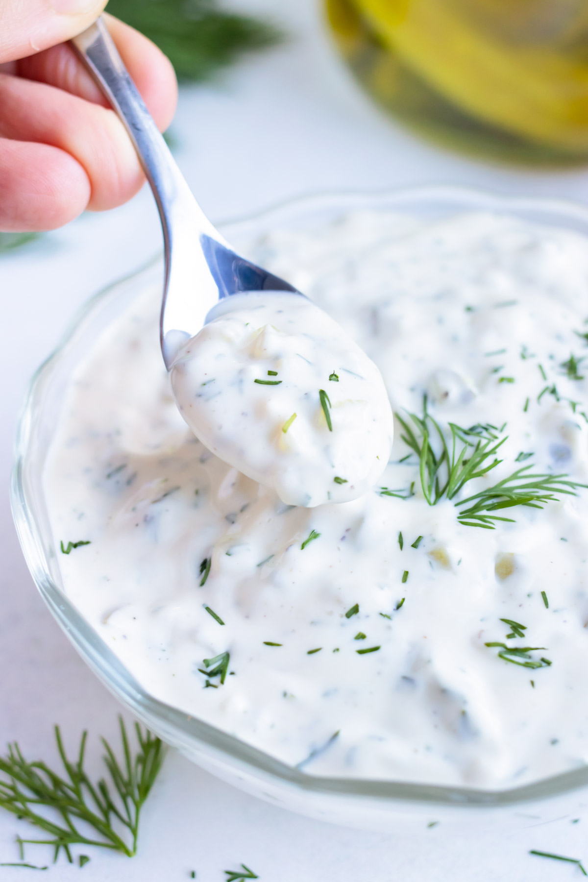 Tartar sauce recipe is served with a spoon for serving with fries or crab cakes.