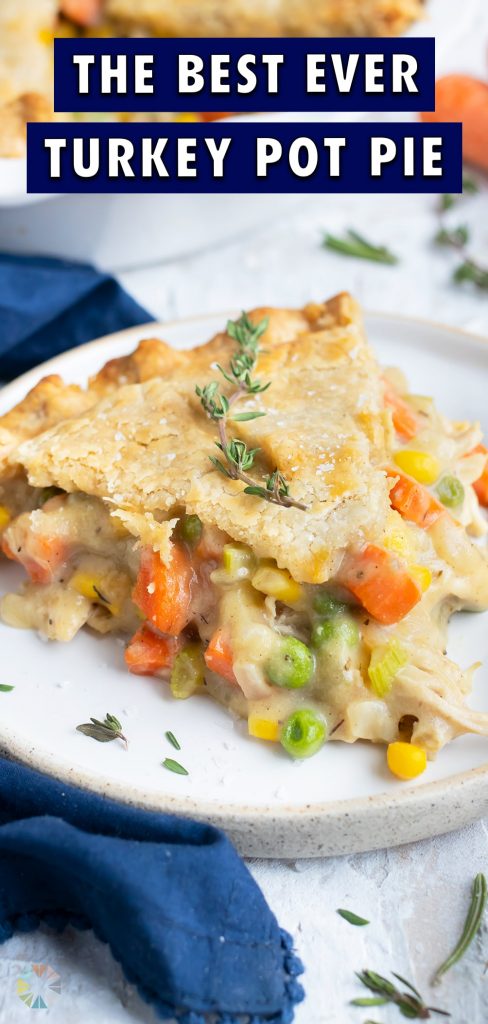 A slice of turkey pot pie is served on a white plate.