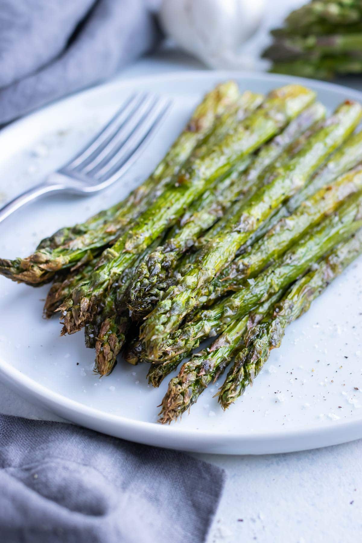 Crispy, low-carb air fryer asparagus is plated for a healthy side.