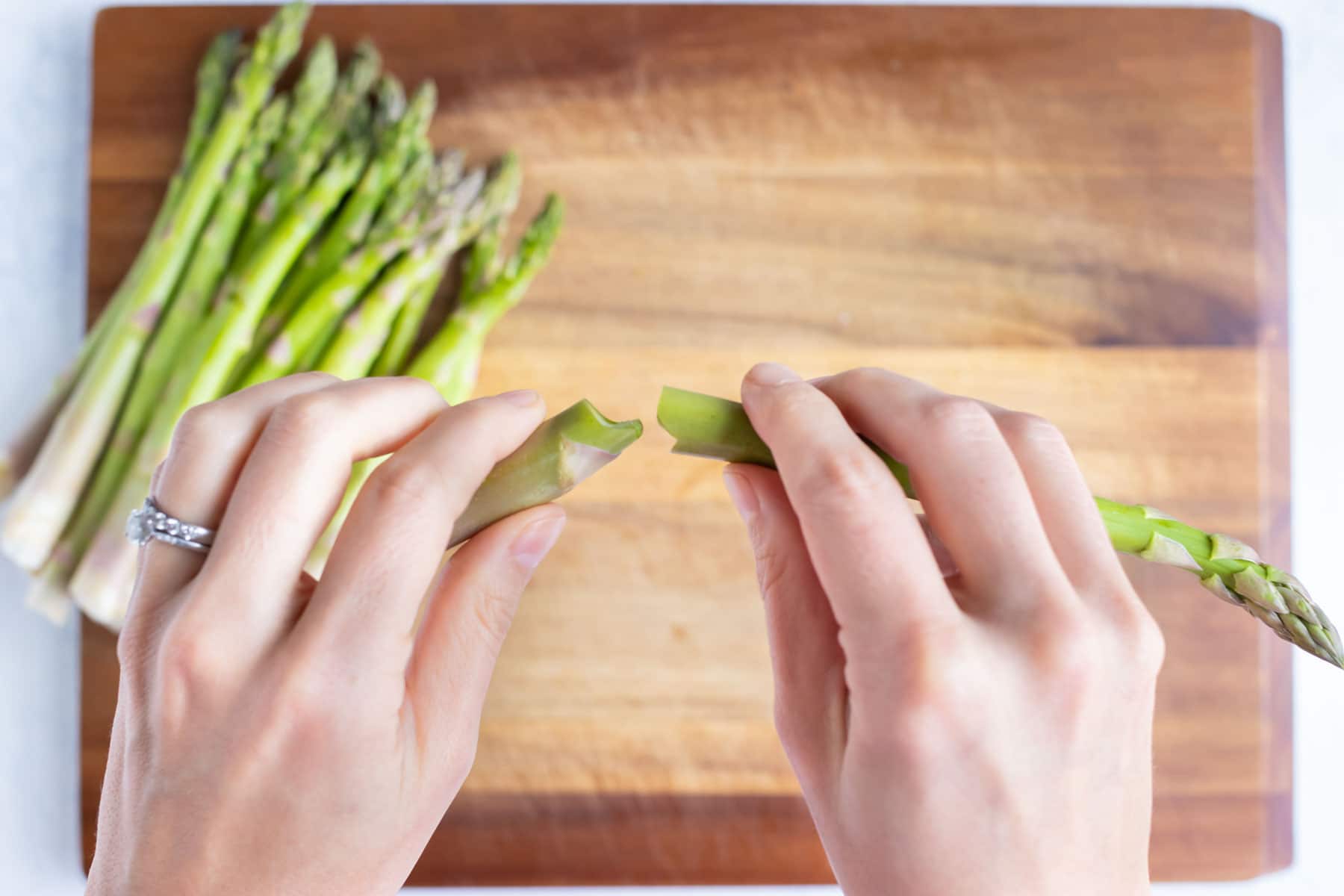 Asparagus ends are snapped off with your hands.
