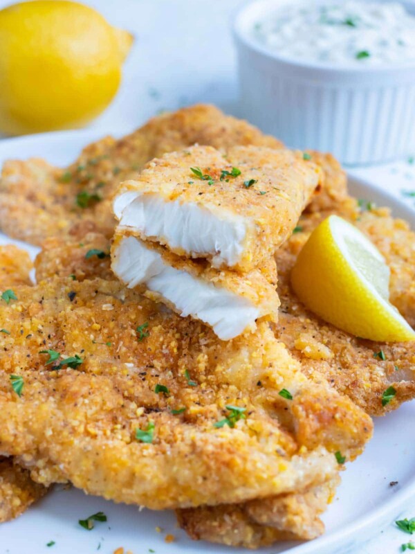 Breaded fish made in the air fryer is served on a white plate.