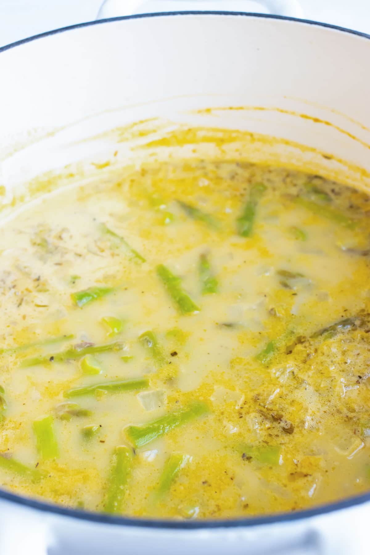 Unblended asparagus soup in a pot.