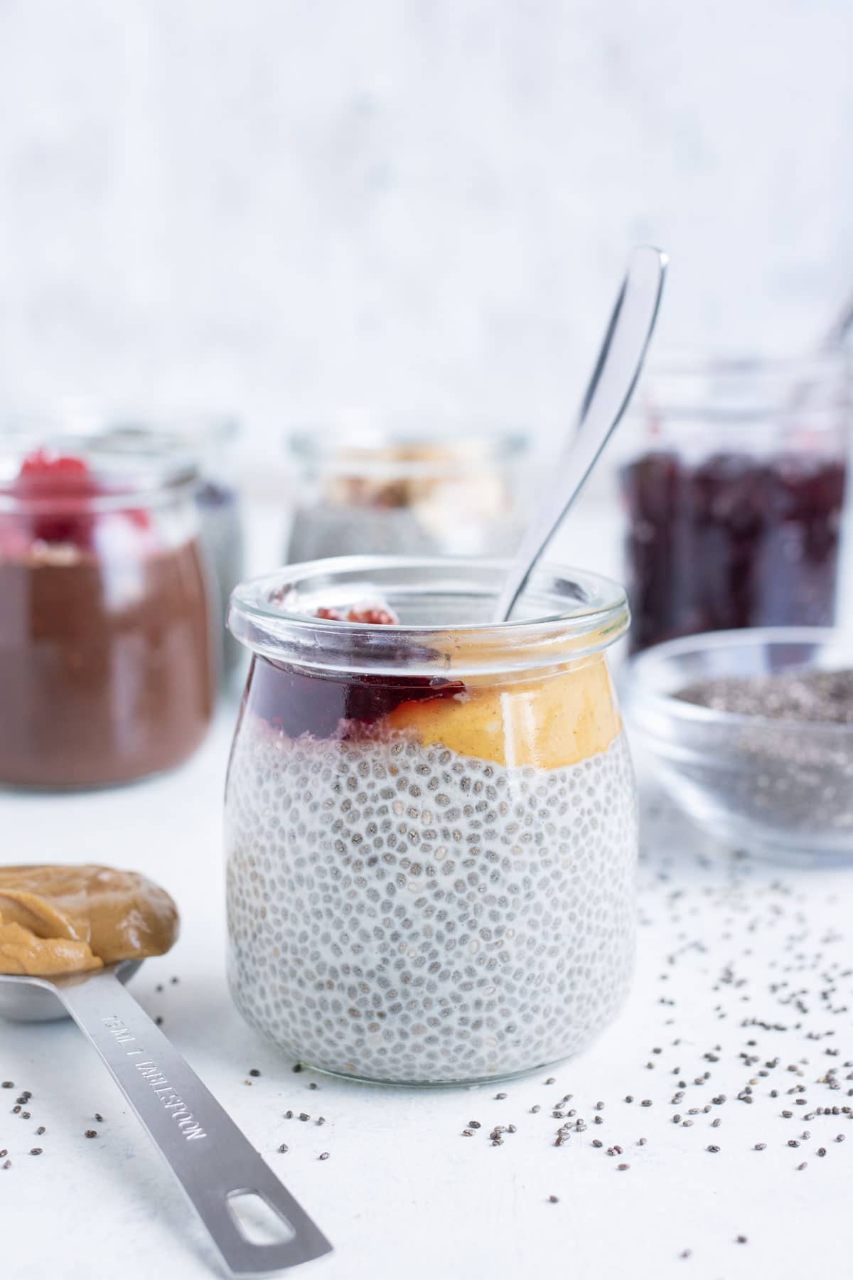 Peanut butter and jelly chia seed pudding is shown on the counter.