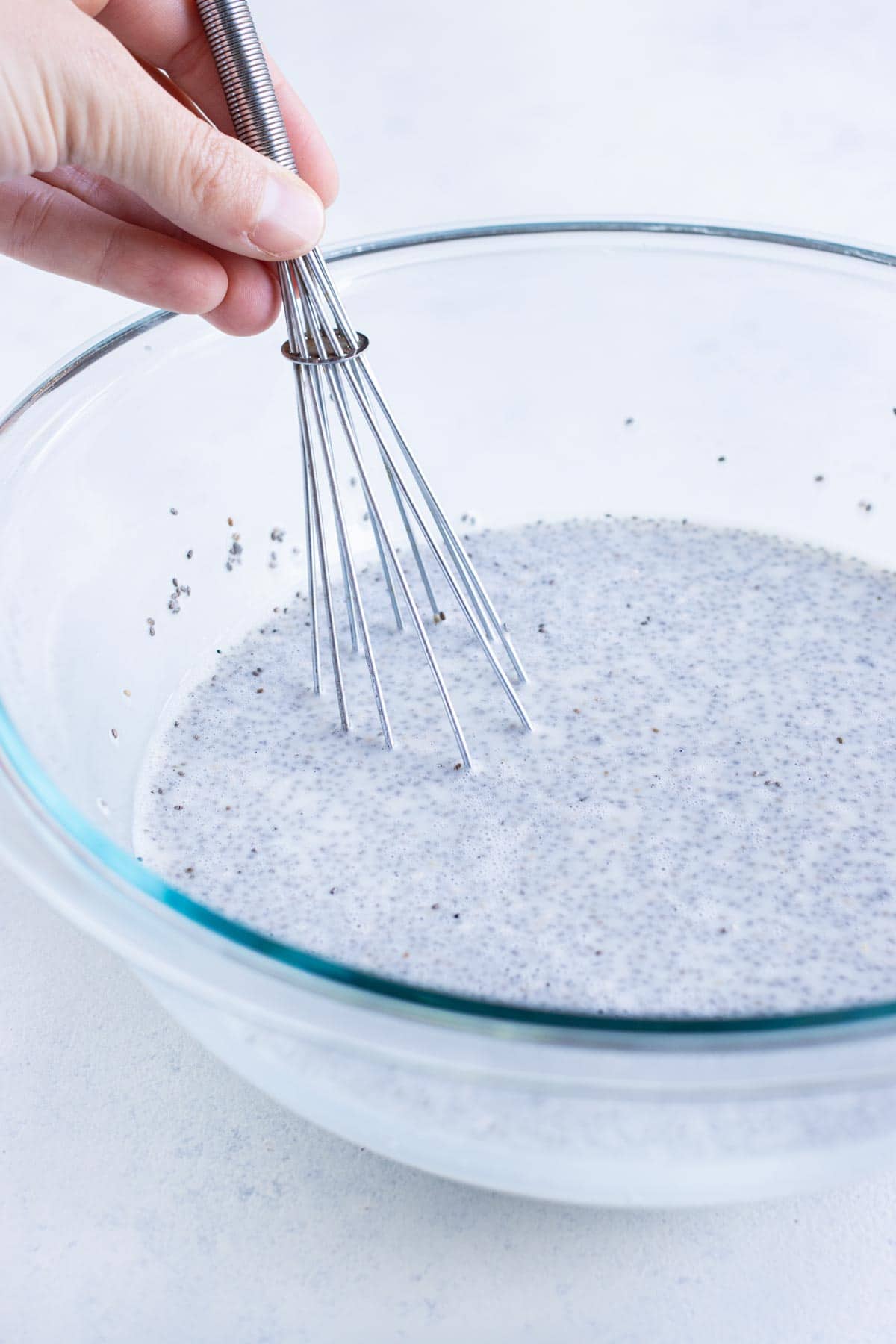 Chia seeds are added and whisked into the milk mixture.