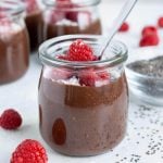 Mason jars are filled with creamy chocolate chia seed pudding.