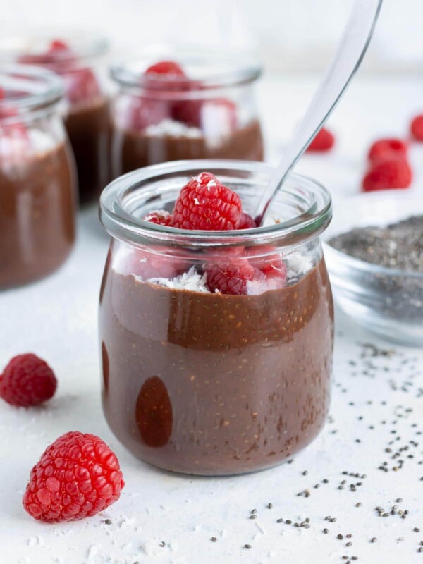 Mason jars are filled with creamy chocolate chia seed pudding.