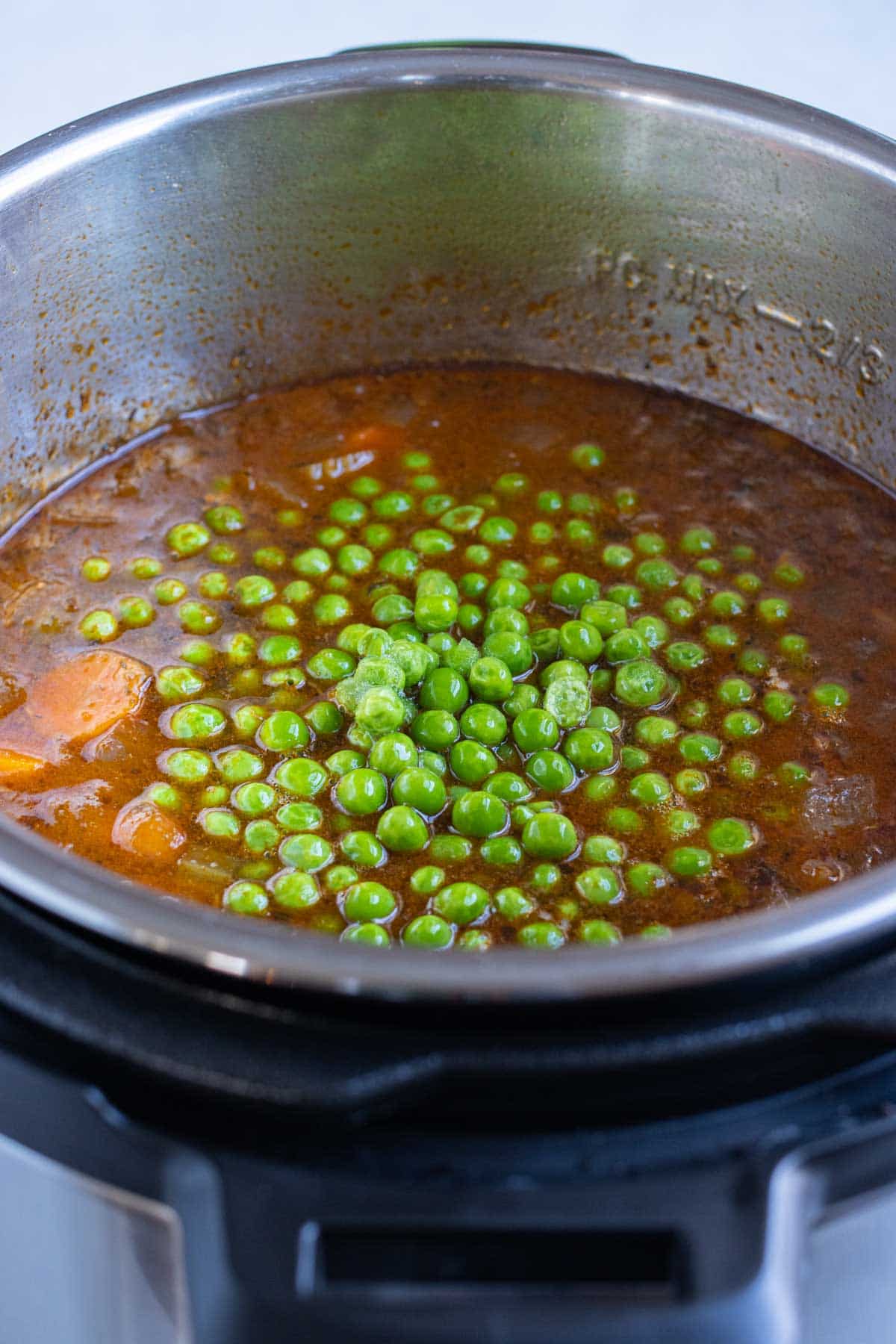 Peas are added last to the beef stew.