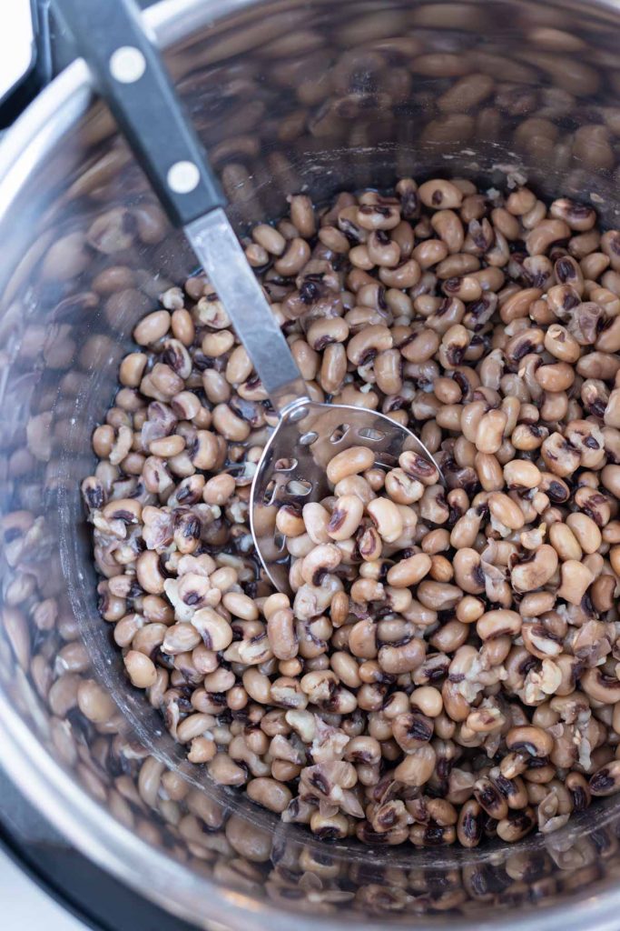 Back eyed peas are removed from the instant pot for a side dish.