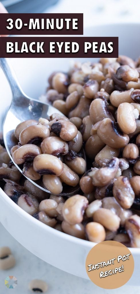 Tender, cooked black eyed peas are served with a spoon.