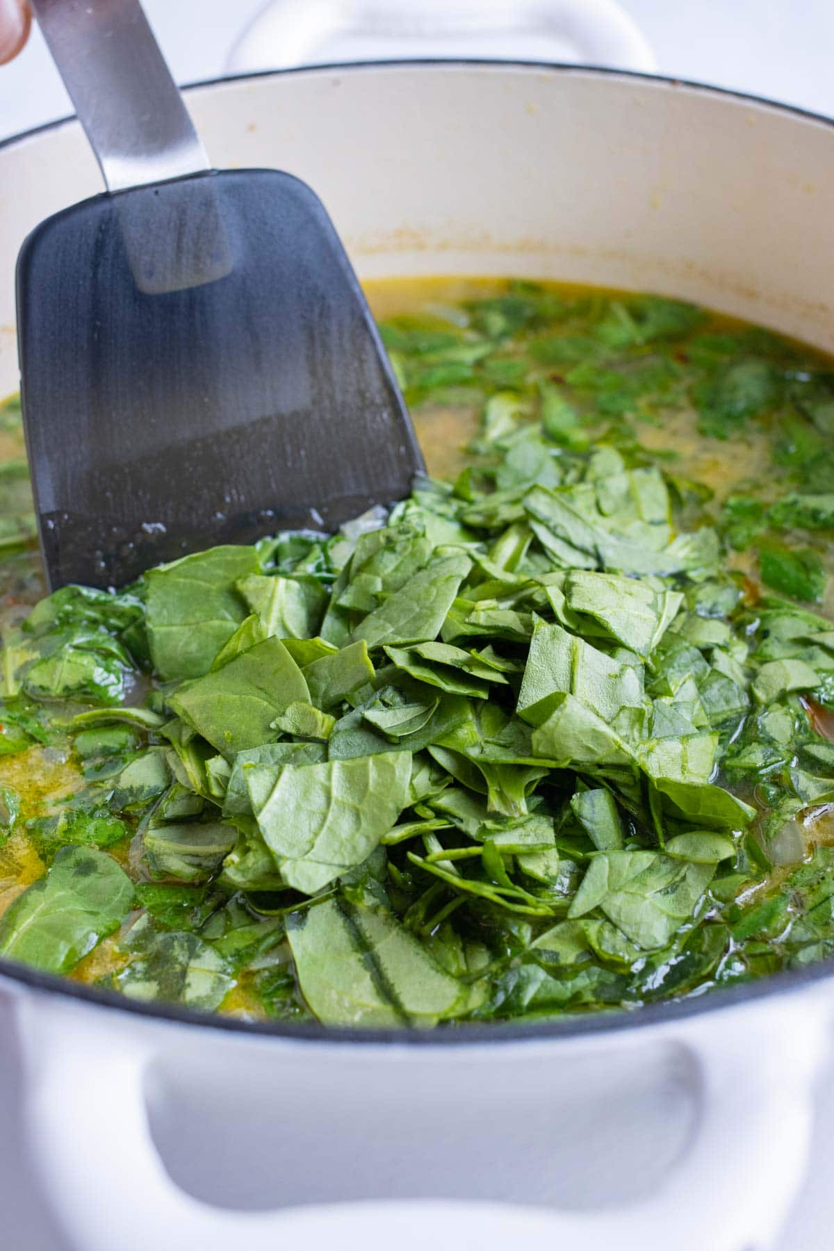 Chopped spinach is added to the Italian Wedding Soup.